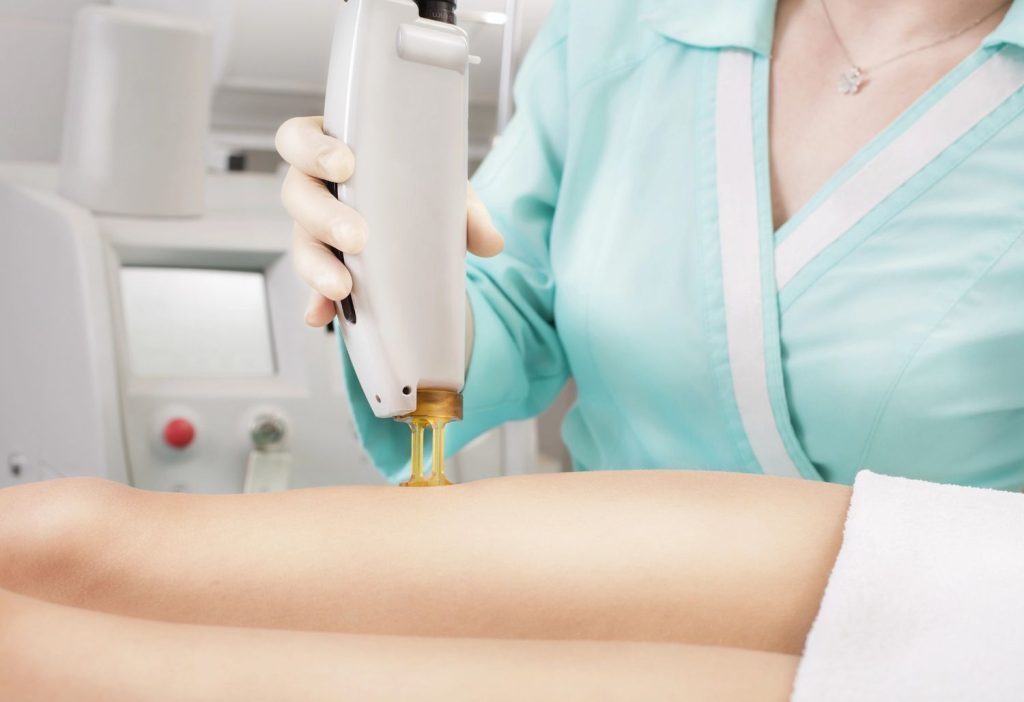 Professional using laser device on legs, perfect for laser hair removal course San Antonio training.