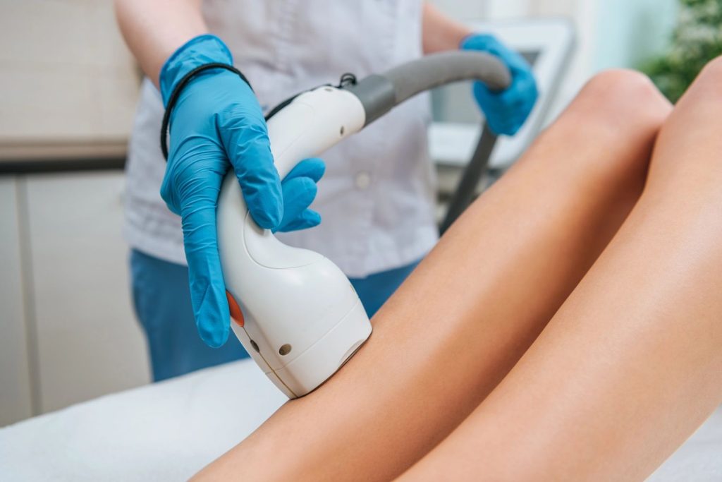 Professional using laser device on legs, perfect for laser hair removal course San Antonio training.