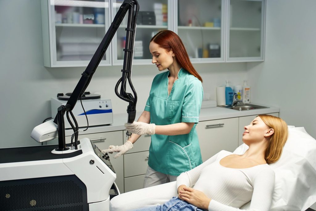Technician performing laser hair removal procedure in course San Antonio, using advanced equipment on relaxed patient for effective hair reduction training.