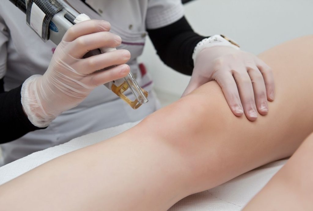 Student practices cosmetic laser leg treatment in clinical setting at laser hair removal school San Antonio program