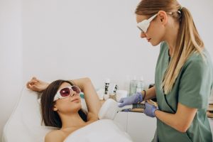 Laser hair removal school San Antonio hands-on underarm laser training with protective eyewear in supervised cosmetic clinic environment
