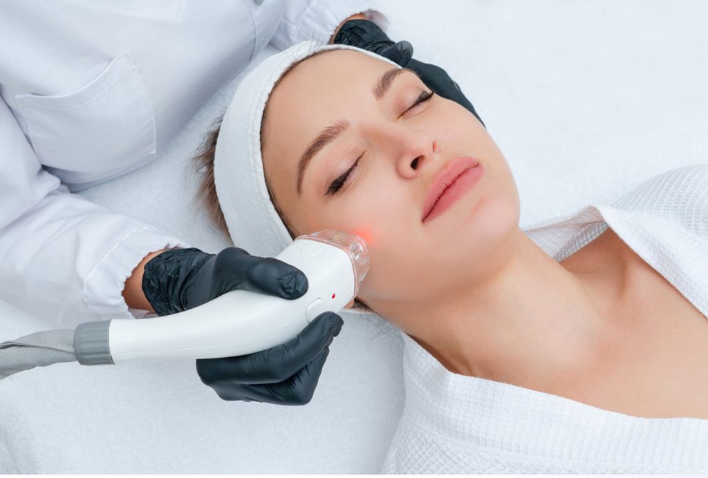 Student at a laser hair removal academy performing a professional facial skin rejuvenation treatment on a client.