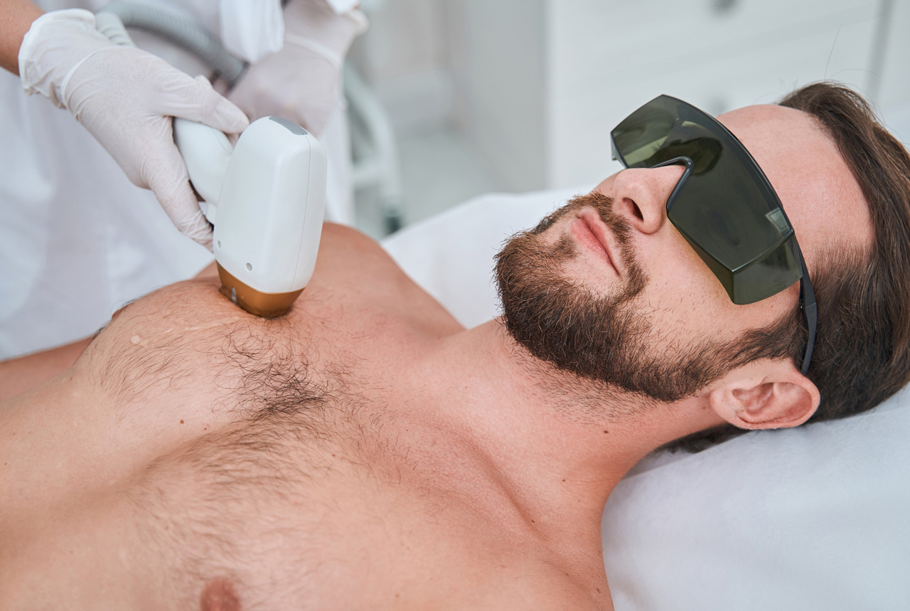 Professional chest laser hair removal school Woodlands session featuring a male client and expert laser technician.