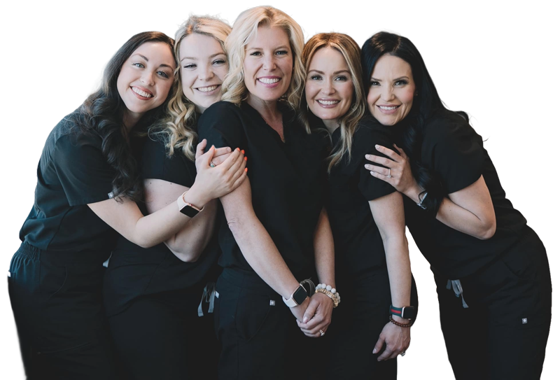 A group of smiling professional technicians in black scrubs representing the community and success of our laser hair removal classes Woodlands.