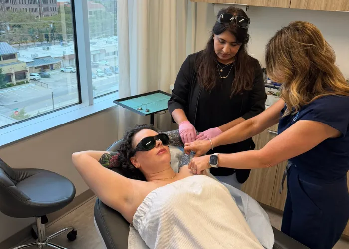 Two specialists treating a patient's underarm area during an El Paso laser hair removal hands-on training class.