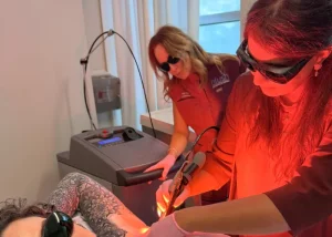 Two specialists performing a clinical underarm laser session during Houston laser hair removal hands-on training.