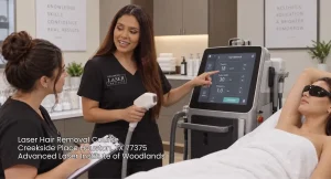 Instructor explaining device settings on a touchscreen machine during a professional laser hair removal course session.